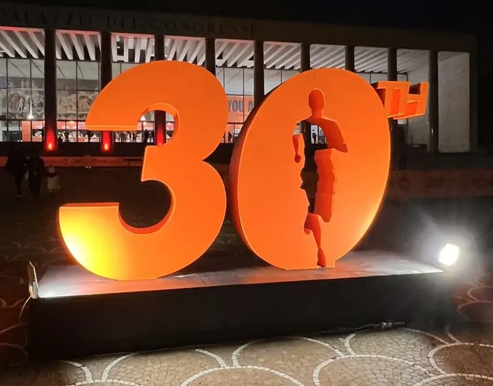 La scritta «30th» illuminata davanti al Palazzo dei Congressi, simbolo della 30ª Maratona di Roma