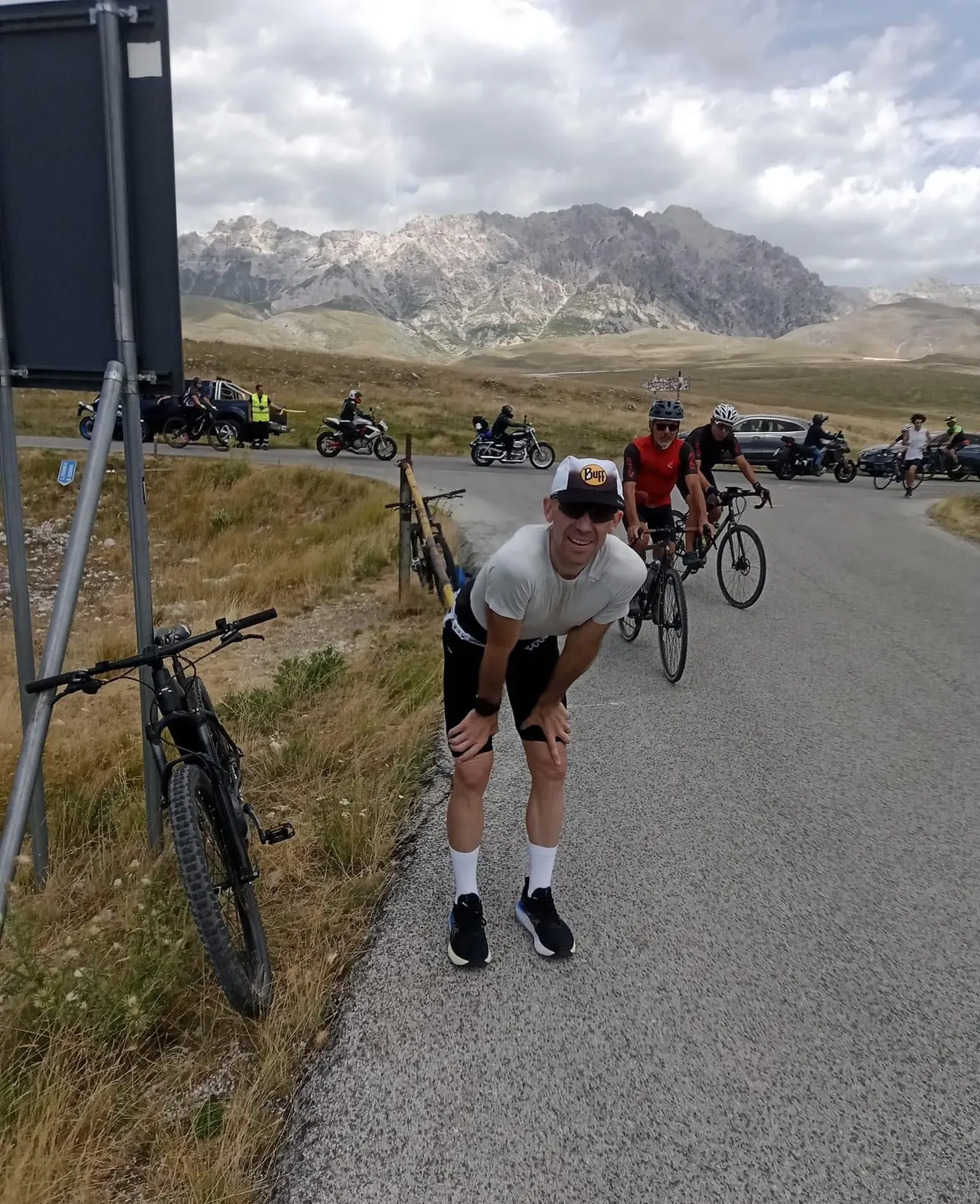 Raffaele riprende fiato a bordo strada, tra le bici dell'assistenza